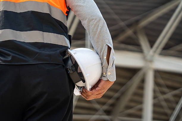 istock Asian senior engineer man or architect looking forward with white safety helmet in construction site. Standing at modern building construction. Professional asian man working project building 2215528205