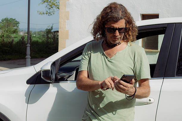 istock Latino man with his car 2215533967