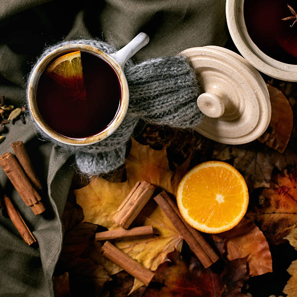 istock Hot mulled wine with spices and autumn leaves 2215540487