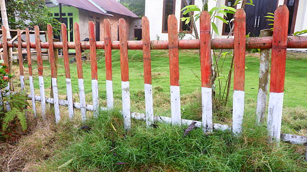 istock a simple wooden fence painted red and white 2215543489