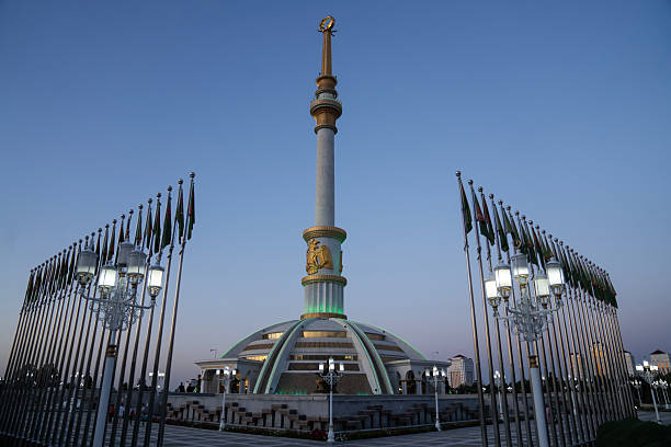 Ashgabat, Turkmenistan - April 26, 2024: The Independence Monument at dusk. Built by Turkish company Polimeks, the design is said to be inspired by traditional Turkmen tents and female headwear.