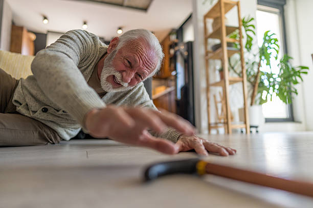 istock Retired Man on Ground After Fall Attempting to Grab Cane 2215546037