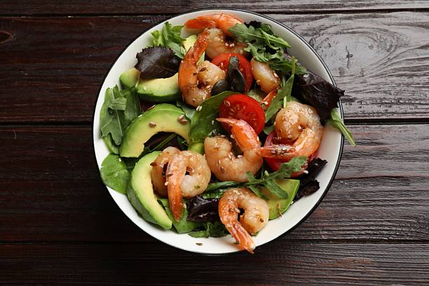 istock Delicious shrimp salad on wooden table, top view 2215546049