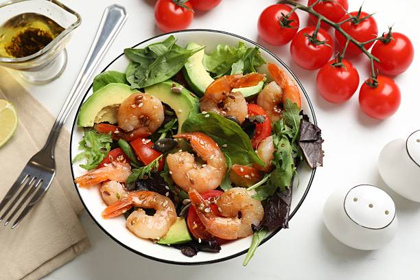 istock Delicious shrimp salad and ingredients on white table, flat lay 2215546064