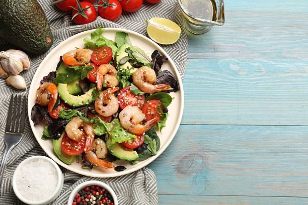 istock Delicious shrimp salad and ingredients on light blue wooden table, flat lay. Space for text 2215546068