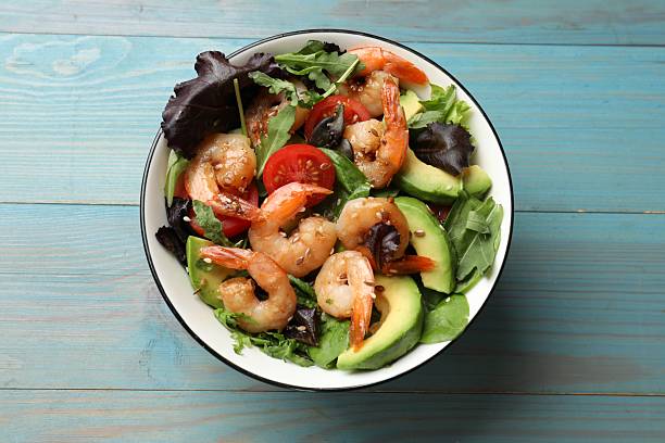 istock Delicious shrimp salad on light blue wooden table, top view 2215546072