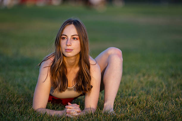Blonde sporty woman is practicing in nature at public park.
