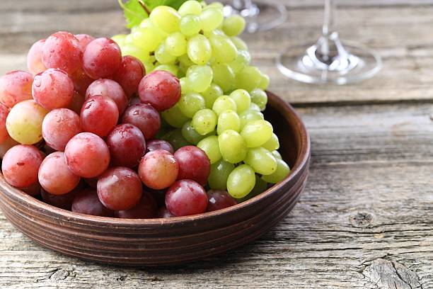 istock Delicious fresh ripe grapes on wooden table 2215548249