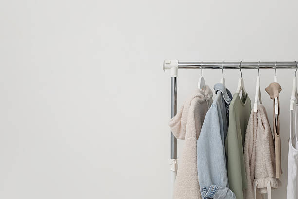 istock Rack with clothes near white wall. Space for text 2215548535