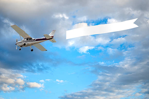 istock Airplane with banner in cloudy day 2215548539