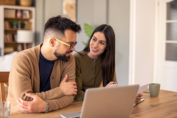 istock Young Professionals Collaborating Together at Laptop in Bright and Natural Office Setting 2215548638