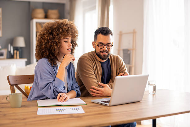 istock Young Professionals Review Business Data On Laptop In Sun-Lit Home Office Space 2215548838