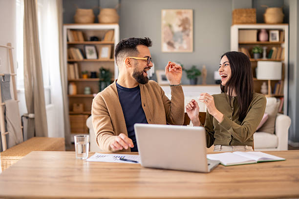 istock Joyful Business Partners Celebrating Success While Working Together At Modern Home Office 2215548840