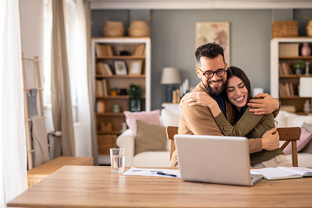 istock Young Professionals Share Joyful Moment While Working From Home Office With Natural Light 2215548846