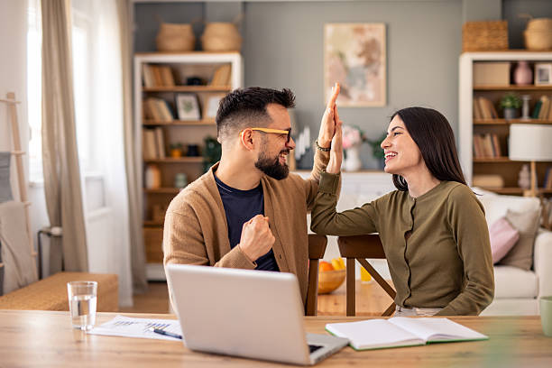 istock Young Professional Colleagues Share High Five Celebration In Sunlit Home Office Setting 2215548853