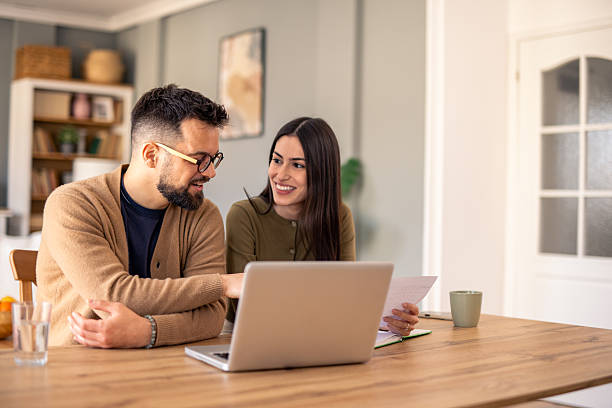 istock Young Professionals Collaborating on a Laptop in a Bright Natural Workspace 2215548859