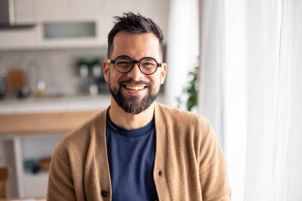 istock Smiling Man with Glasses in a Bright Modern Home Interior 2215548872