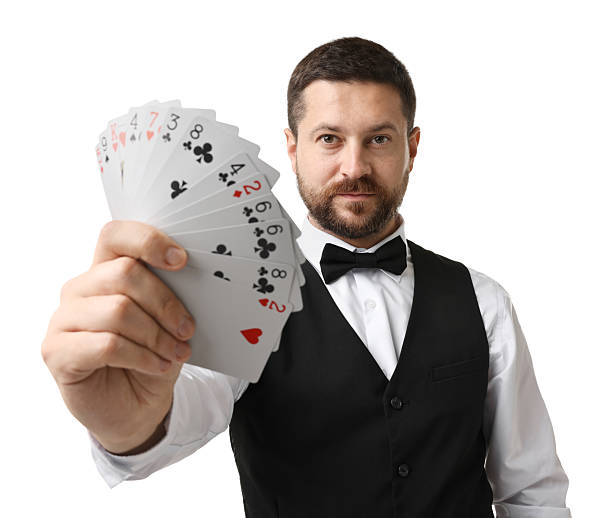 istock Professional croupier with playing cards on white background 2215549122