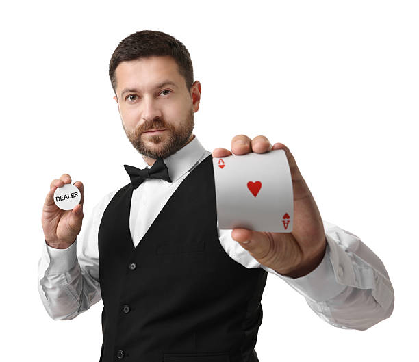 istock Croupier holding card and dealer button on white background 2215549141