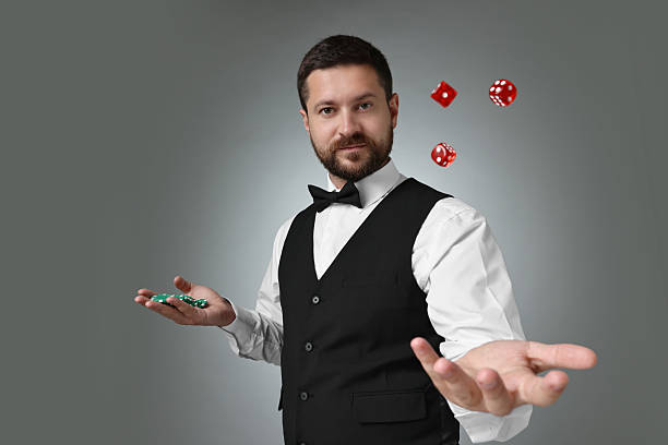 istock Professional croupier with dice and casino chips on grey background 2215549153