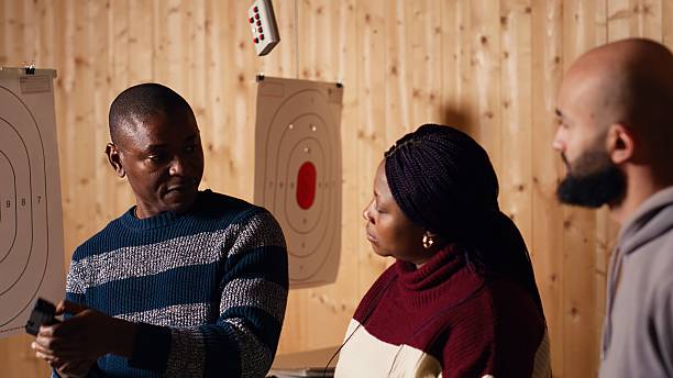 istock Firing range specialist teaching weapon etiquette to clients 2215549880