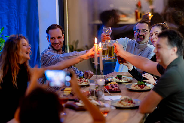 istock Group of friends enjoying a festive dinner together while celebrating with drinks and sharing joyful moments 2215551680
