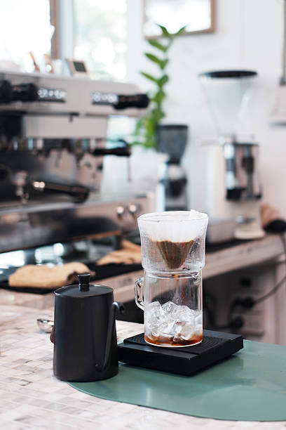 istock Close up black kettle and coffee filter glass on counter in kitchen and cafe 2215554420