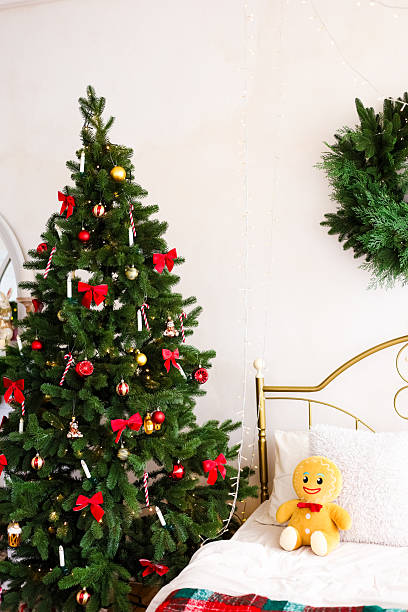 istock Cozy Christmas decor featuring a tree and festive touches in a warm bedroom setting 2215555325