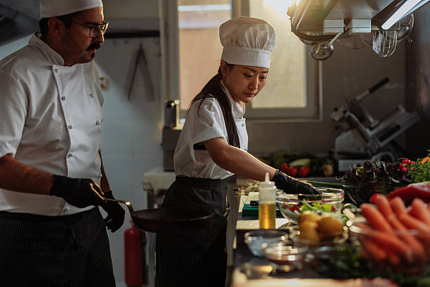 istock Chefs preparing food in a professional kitchen 2215560427
