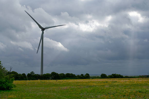 Close-up wind turbines or wind energy converter in sunny day with blue sky and white clouds