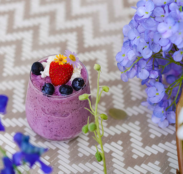 Berry Yogurt Smoothy. A Top view of berry yogurt milkshake including starberry and blueberries on top. Diet and healthy drink. Summer refreshment.