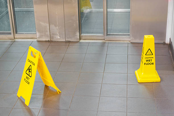 istock Caution wet floor cone safety notice at public stair 2215562664