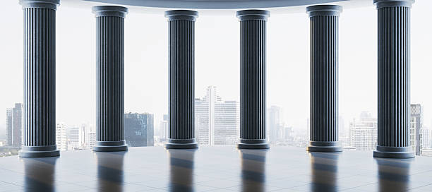 istock Classical stone columns with city skyline in background in modern architectural setting with soft ambient light and polished floor reflection. 3D Rendering 2215568473