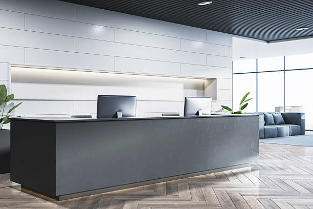 istock Modern corporate reception desk in contemporary office interior with light wall panels, large windows and city view background. 3D Rendering 2215568530