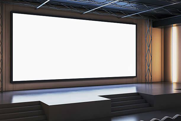 istock Modern empty stage with large digital screen inside a contemporary conference hall for business presentation or corporate event concept. 3D Rendering 2215568548