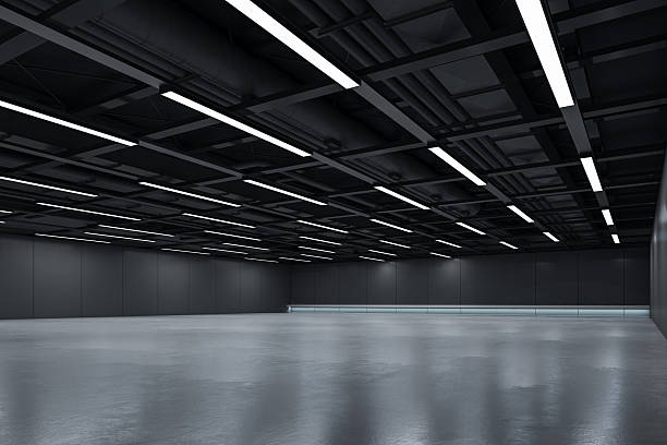 istock Empty industrial interior with dark ceiling lights and clean reflective floor, ideal for branding mockup or modern architectural design template. 3D Rendering 2215569130