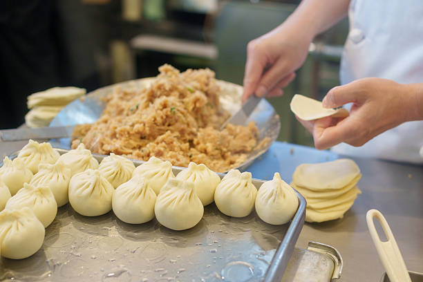 The person making soup dumplings. Xiao long bao.