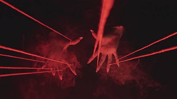 istock Mystical Scene with Hands, Red Strings, and Smoke 2215572529
