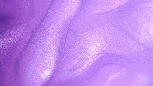 istock a vibrant, pearlescent purple surface with flowing, wave-like swirls 2215574153