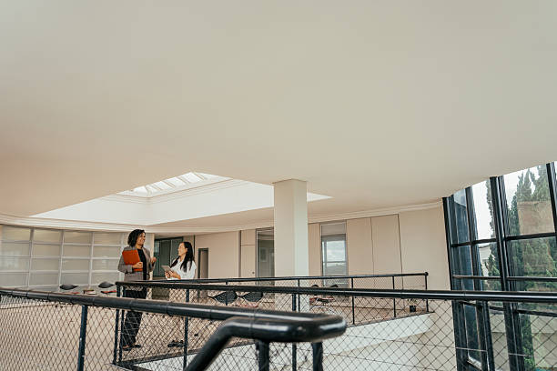 istock Businesswomen talking in a large modern room, robust architecture 2215576445