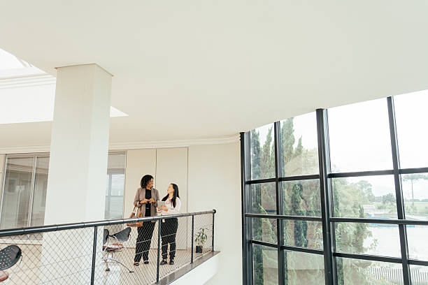 istock Businesswomen talking in a large modern room, robust architecture 2215576458
