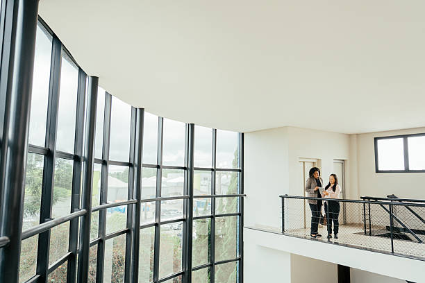 istock Businesswomen talking in a large modern room, robust architecture 2215576470