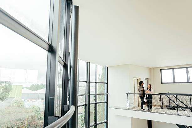 istock Businesswomen talking in a large modern room, robust architecture 2215576480