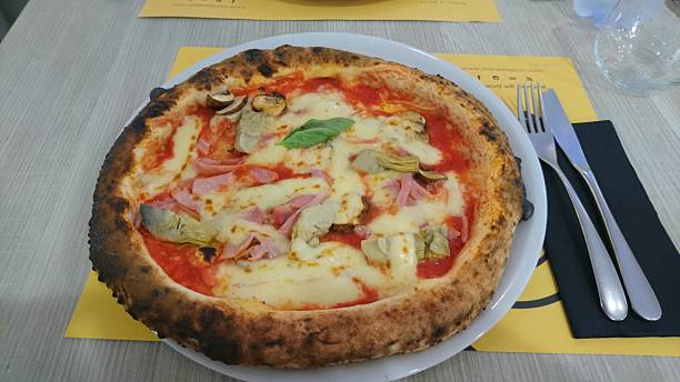 istock Authentic Italian Pizza with Ham, Artichokes, and Mushrooms 2215578470