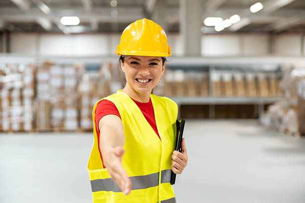istock Female warehouse employee offering handshake with smile 2215579816