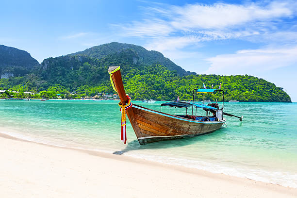istock Thai traditional wooden longtail boat and beautiful sand beach in Phi Phi islands, Thailand. 2215586876