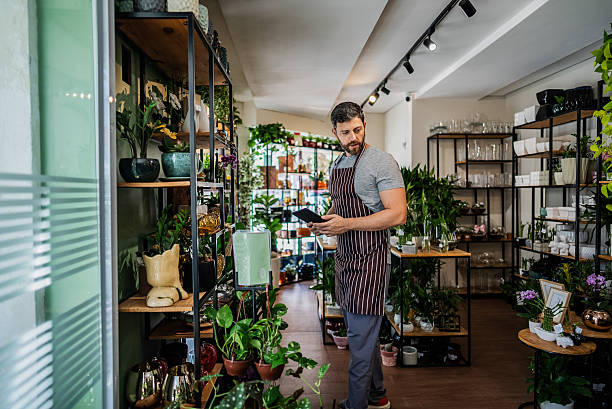 istock Shop owner using digital tablet to manage inventory 2215587004