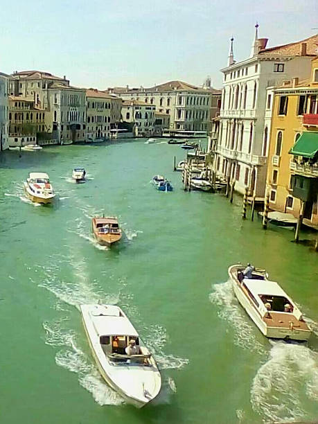 Scenic view of boats in Venice, reflecting the timeless beauty of Italian architecture and waterways.