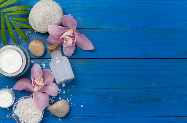 istock Composition with orchids and massage stones on wooden background, top view 2215589297