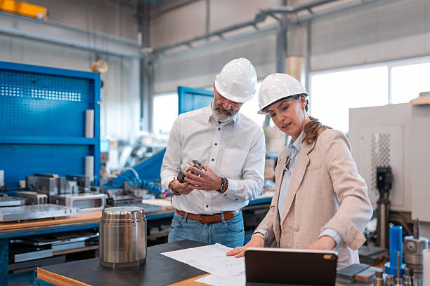 istock Mechanical engineer with customer female manager in production 2215592485